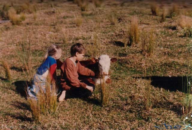 Myself and my sister with a calf